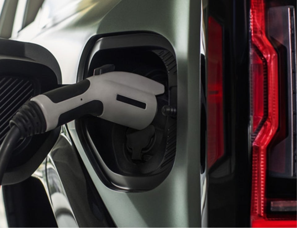 Close up of charging port with charger plugged in on a GMC Hummer EV SUV - Laguna Niguel GMC in Laguna Niguel CA